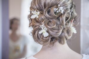 Brides hair in updo with white flowers.