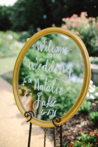 Gold frame used as DIY wedding decor to welcome guest 