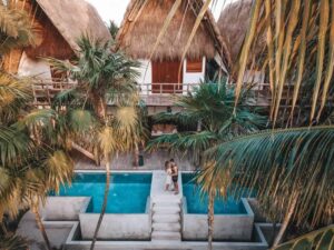 Palm trees, pools, and huts