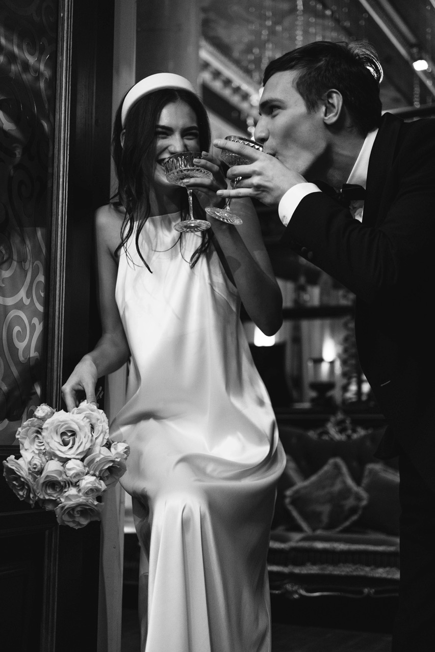 black tie groom and bride sipping cocktail