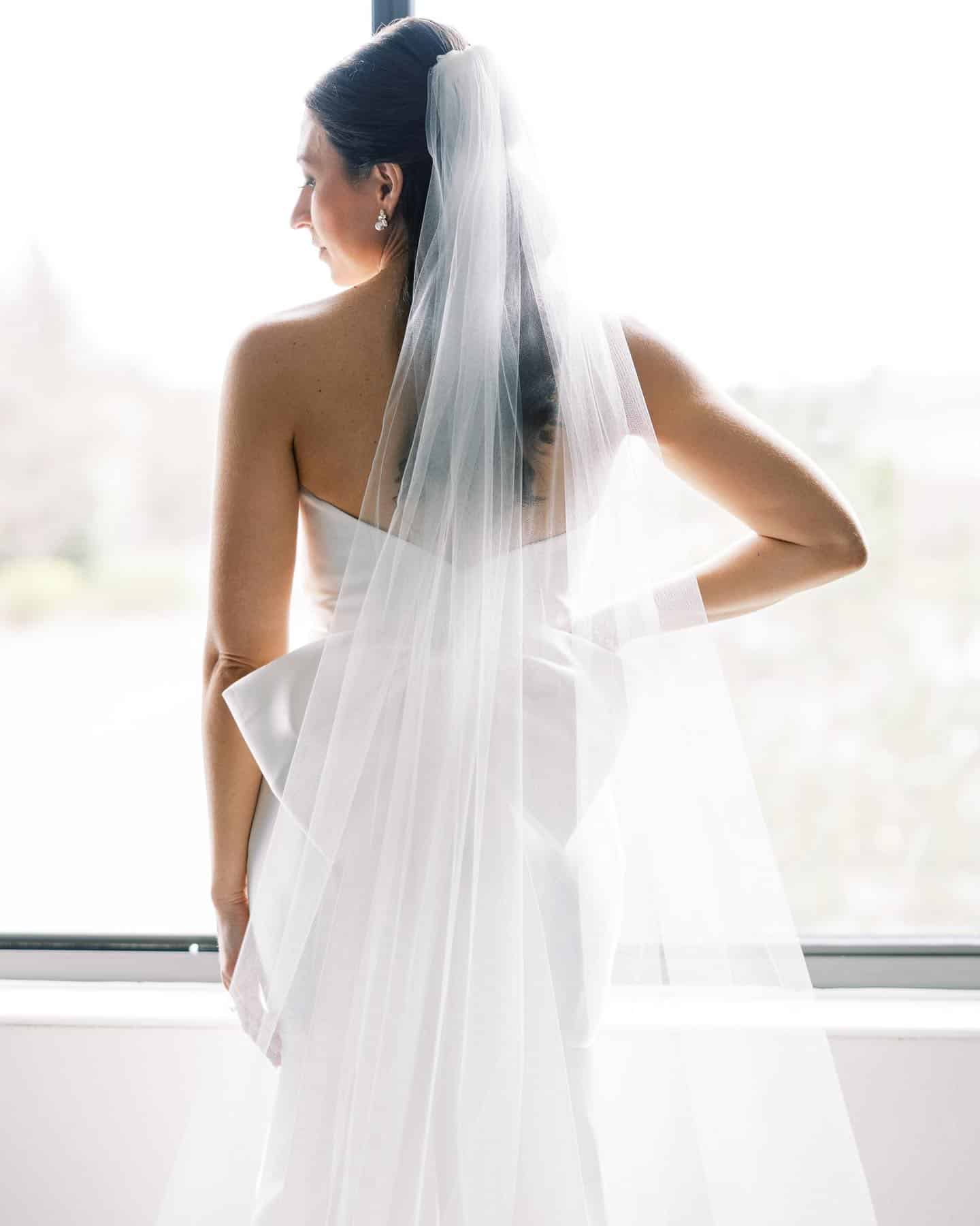 bride standing in front of window