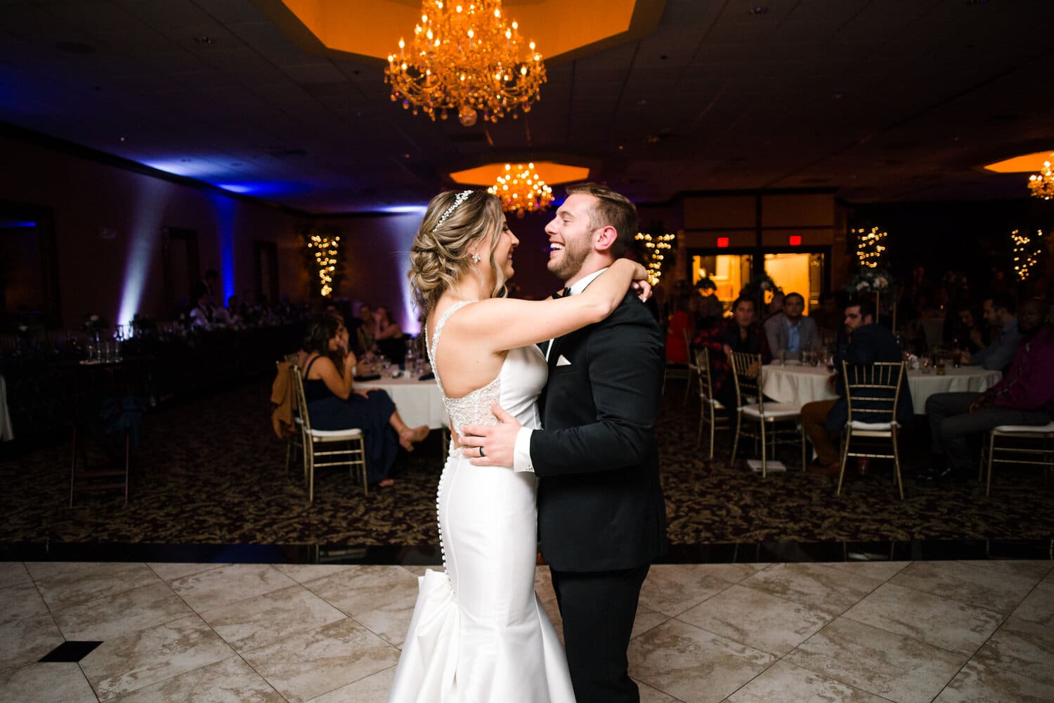 bride and groom dancing in ballroom